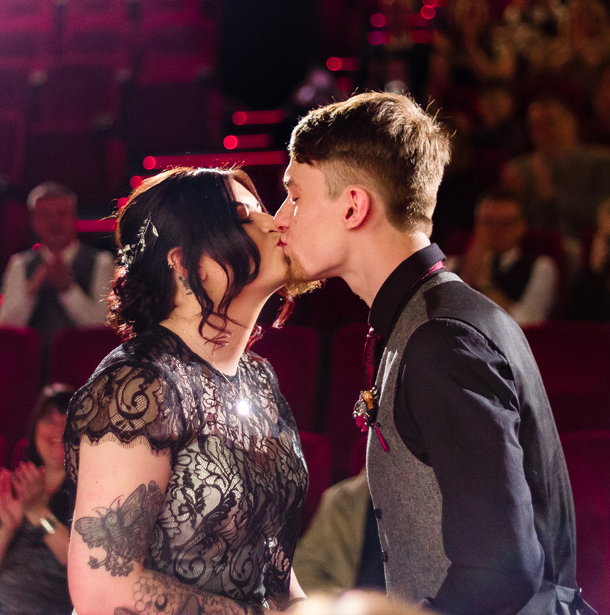 wedding photography: Couples first kiss at cinema wedding
